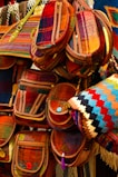 A collection of colorful handmade bags arranged artfully on a wooden shelf