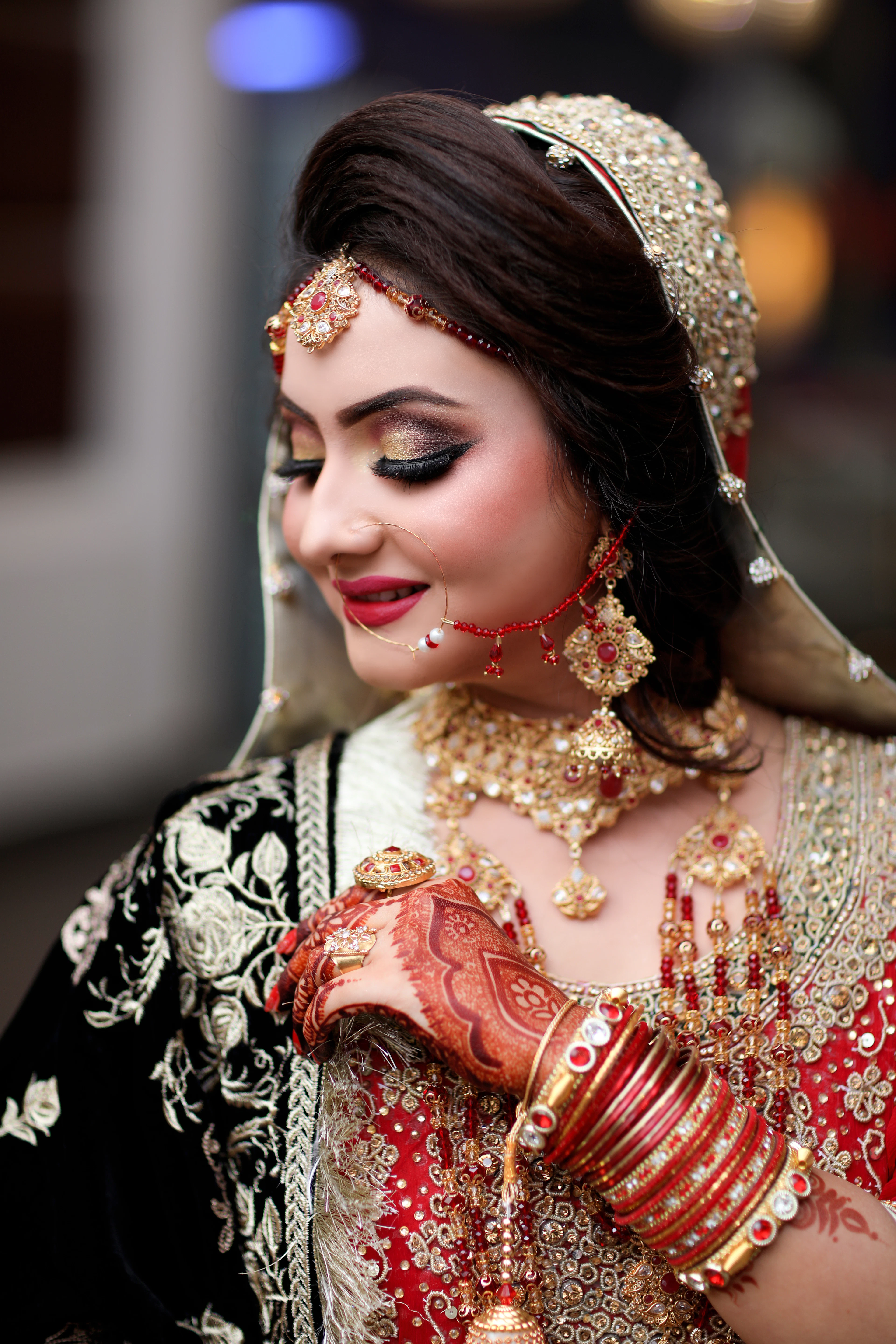 Bride in black velvet and gold with henna