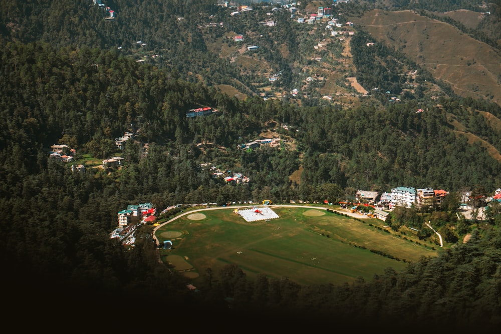 an aerial view of a baseball field surrounded by trees