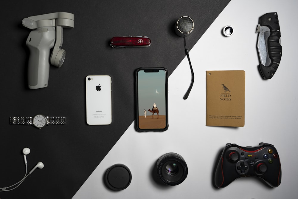 a collection of electronics and gadgets laid out on a table