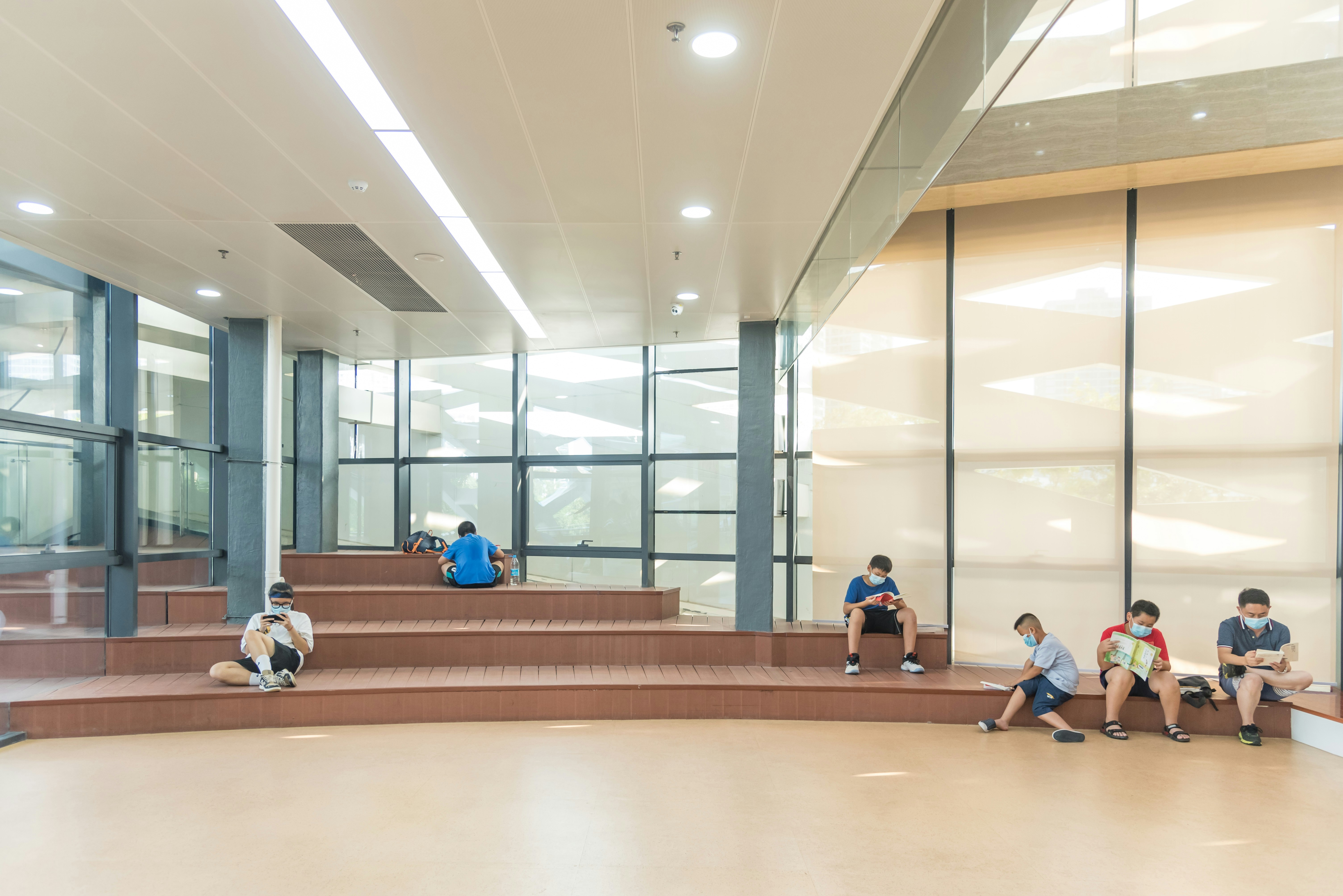a group of kids sitting on the steps of a building