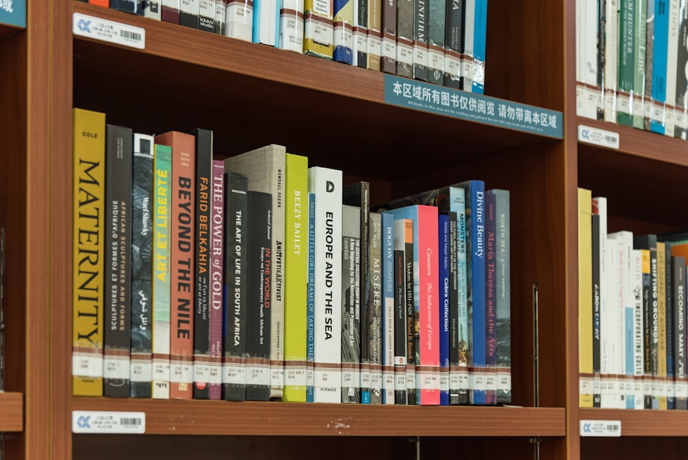 a bookshelf filled with lots of different colored books