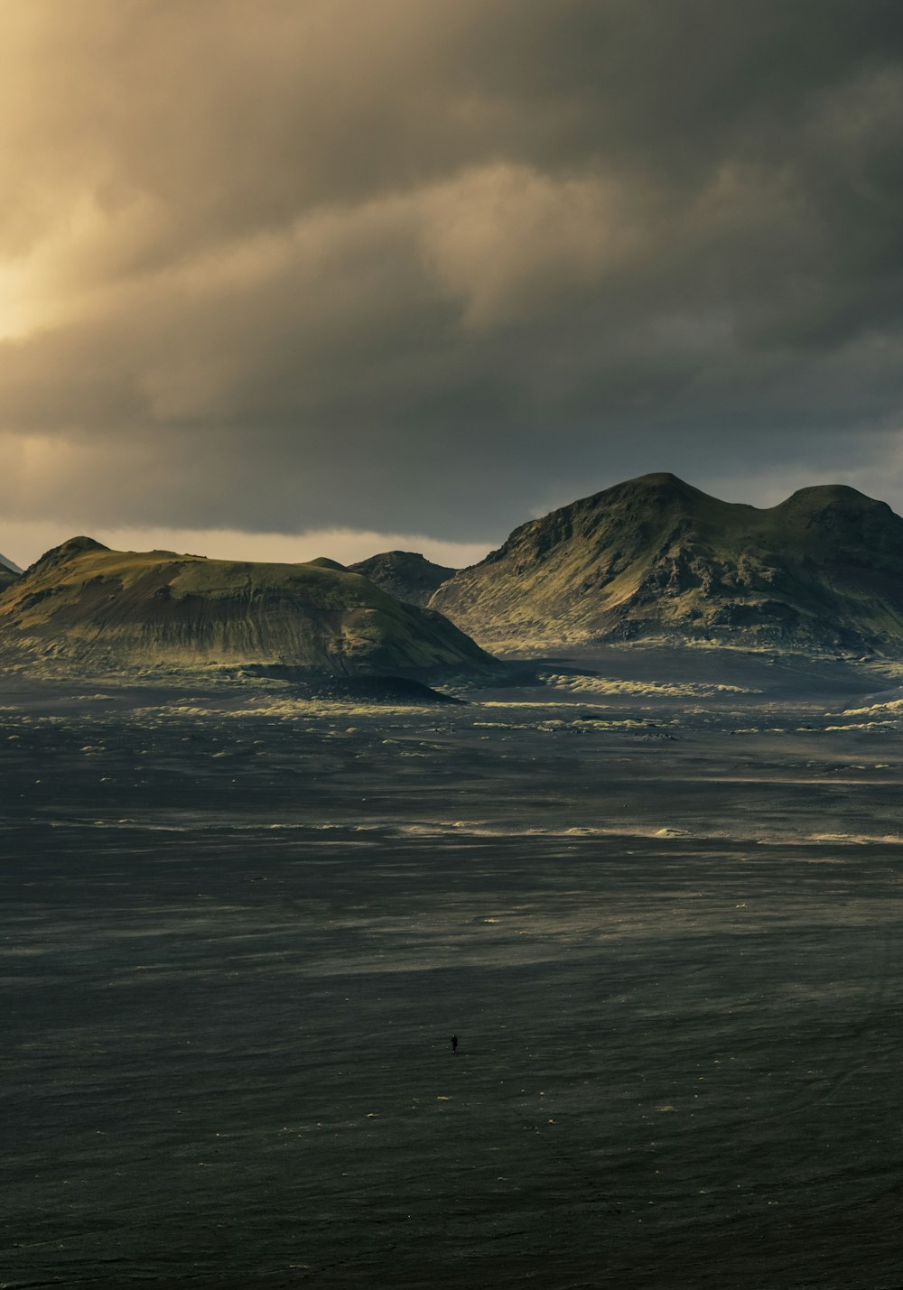 a couple of hills sitting in the middle of a field