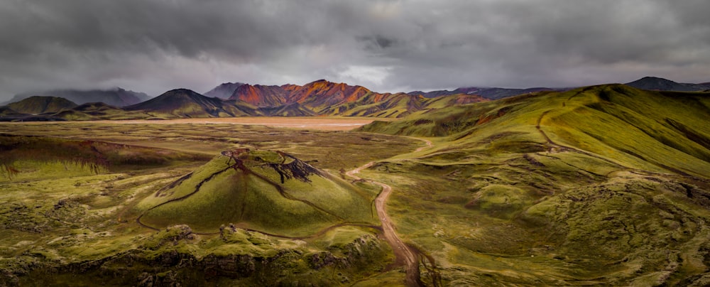 an aerial view of a valley with mountains in the background