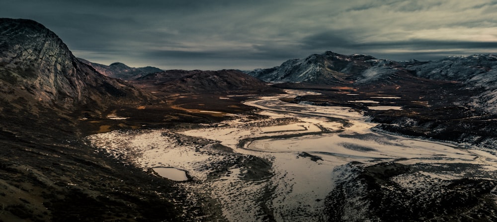 an aerial view of a mountain range with a river running through it