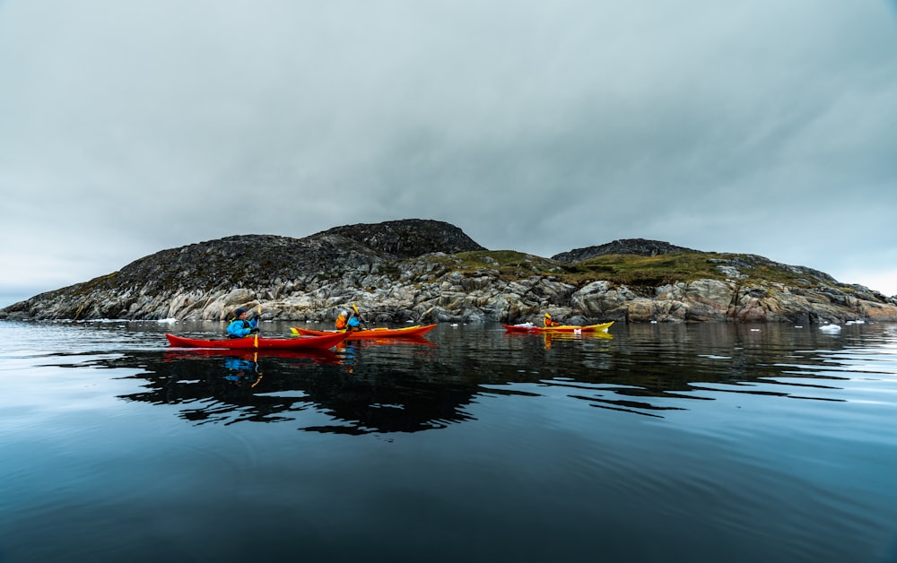 a group of people in kayaks on a body of water