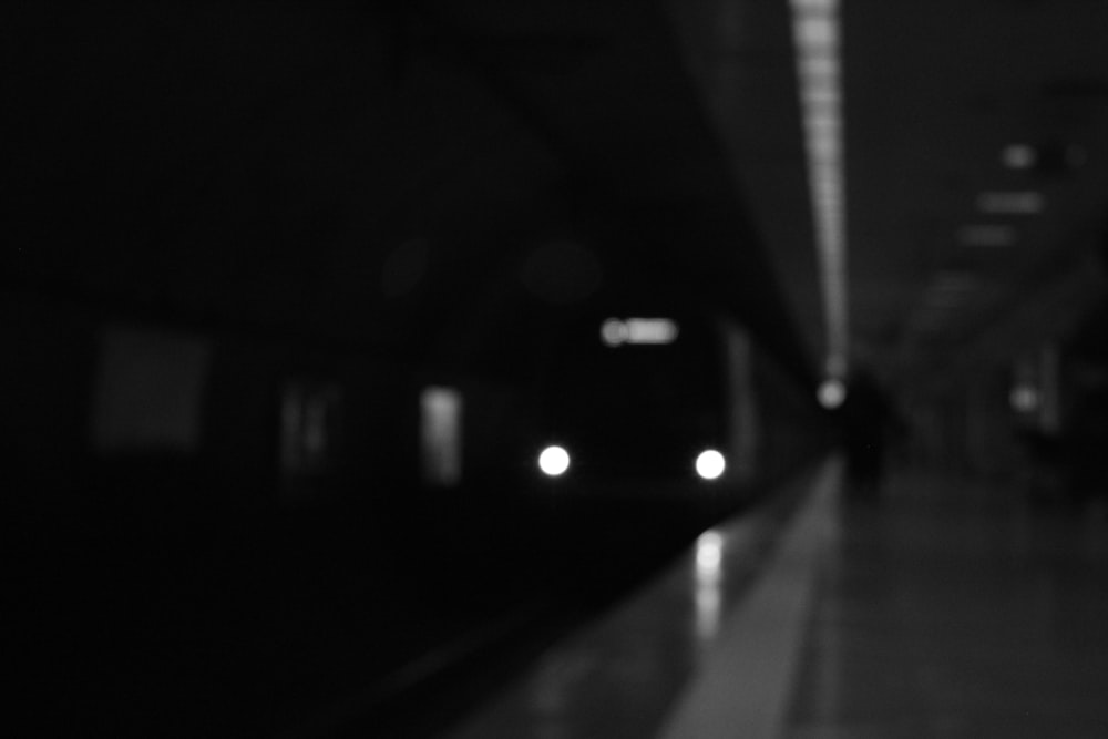 a black and white photo of a subway station