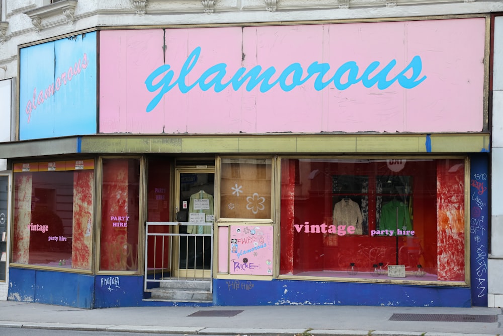 a store front with a pink and blue sign on it
