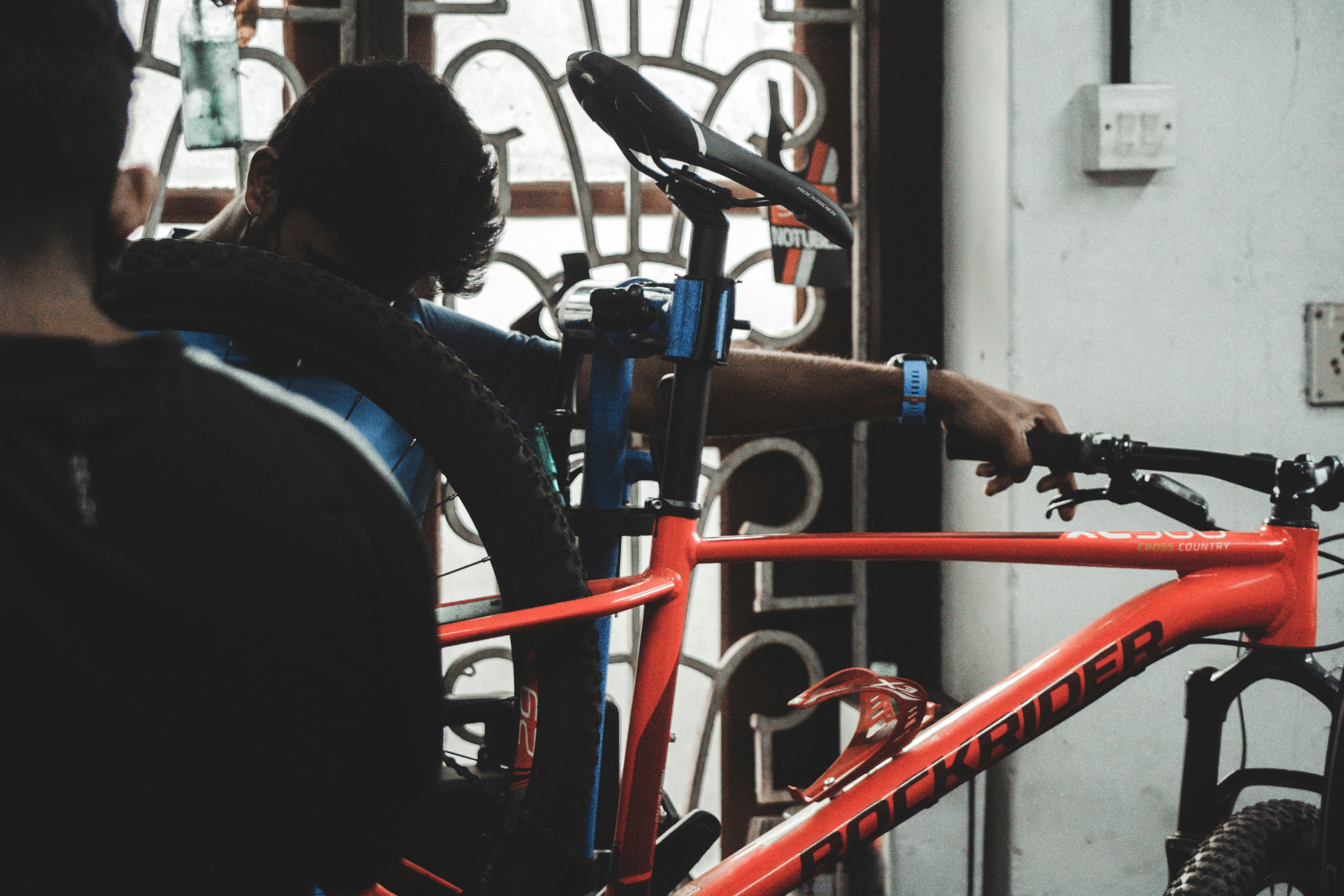 a man standing next to a bike in a garage