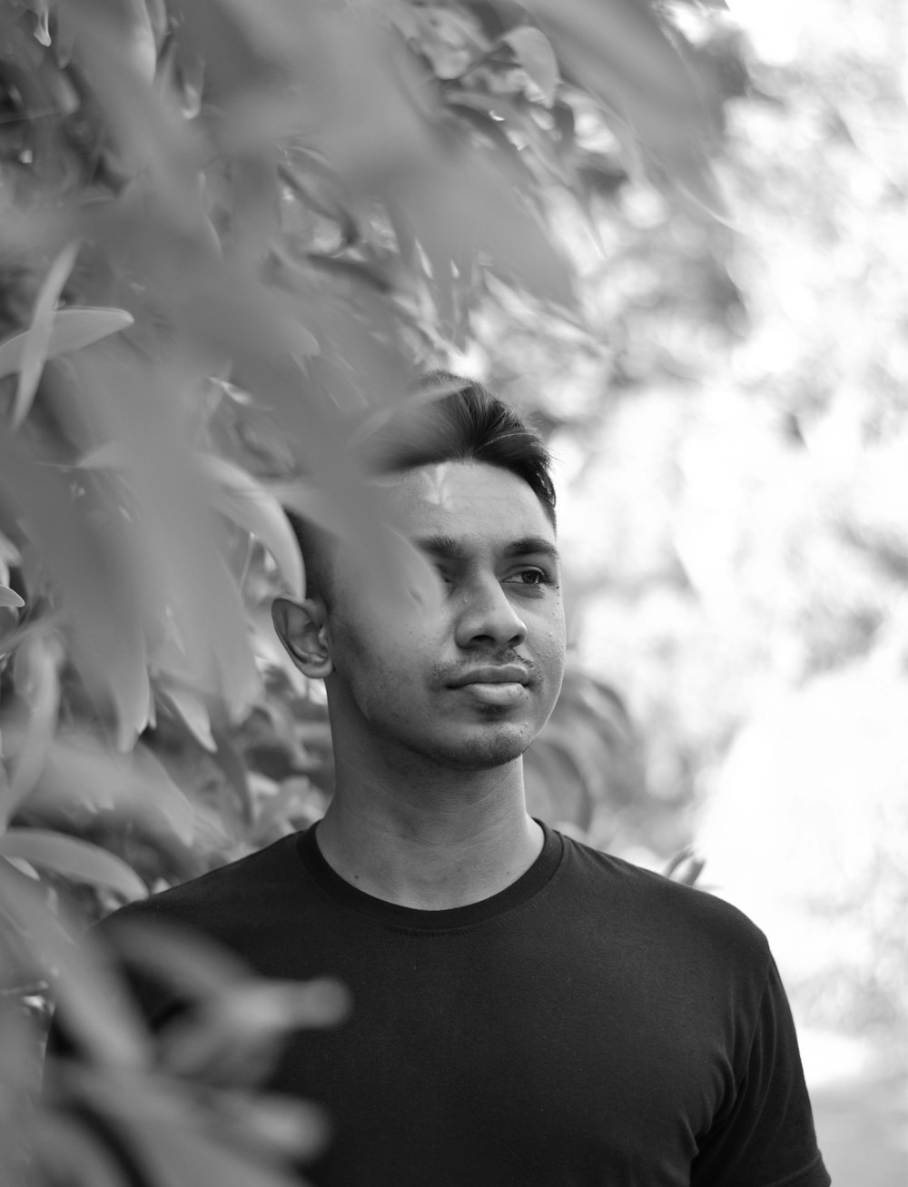 a black and white photo of a man in a black shirt