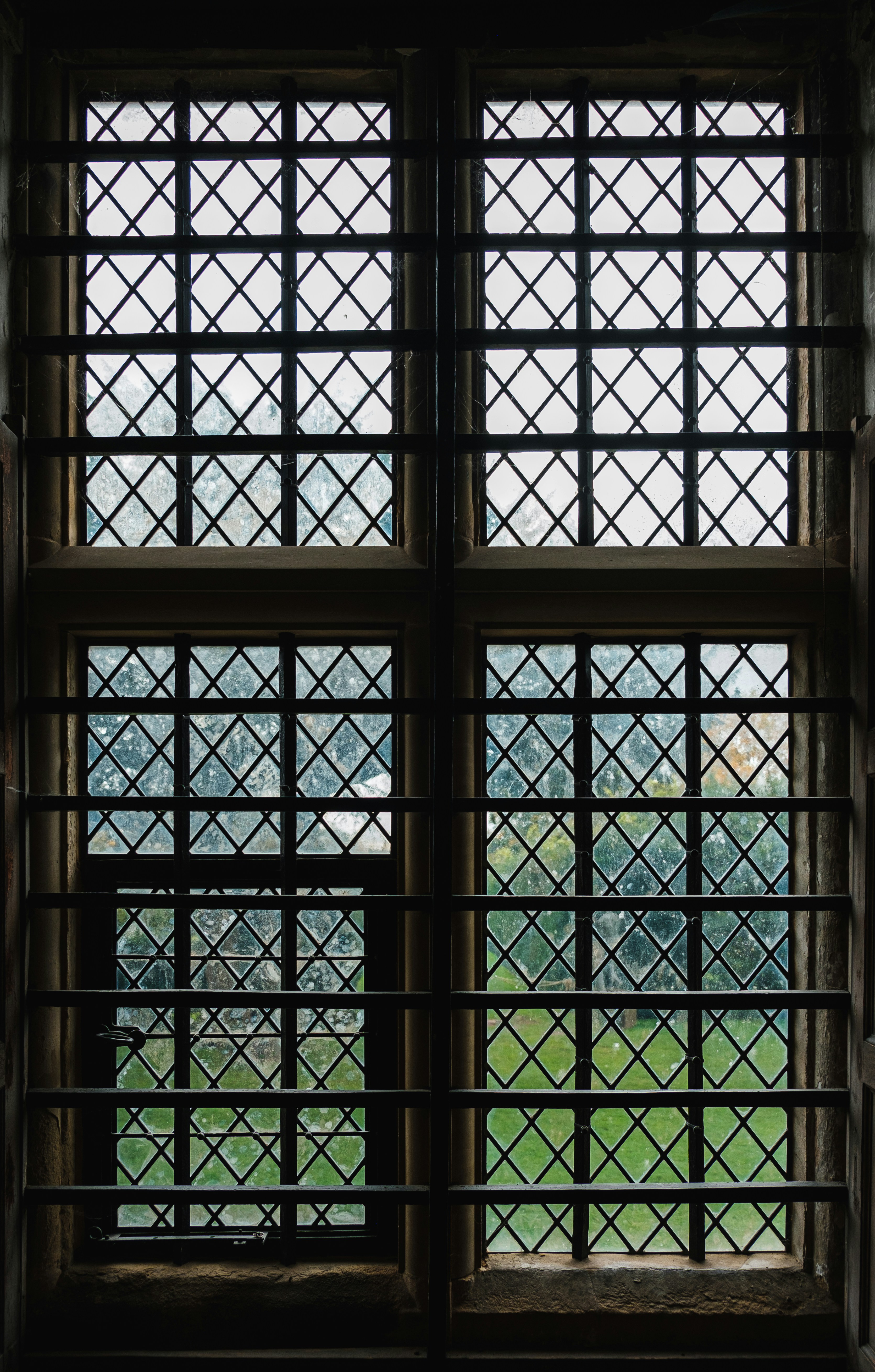 A view of a grassy field through a window photo – Free Window Image on ...