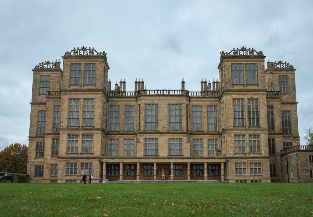 a large brown building with lots of windows