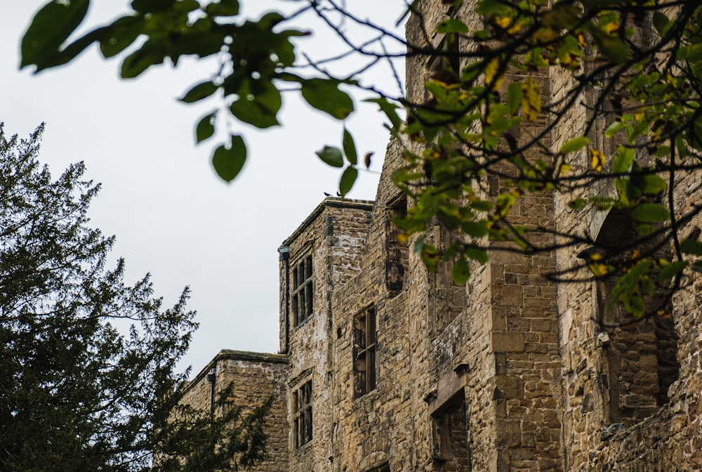 a stone building with a clock on the front of it