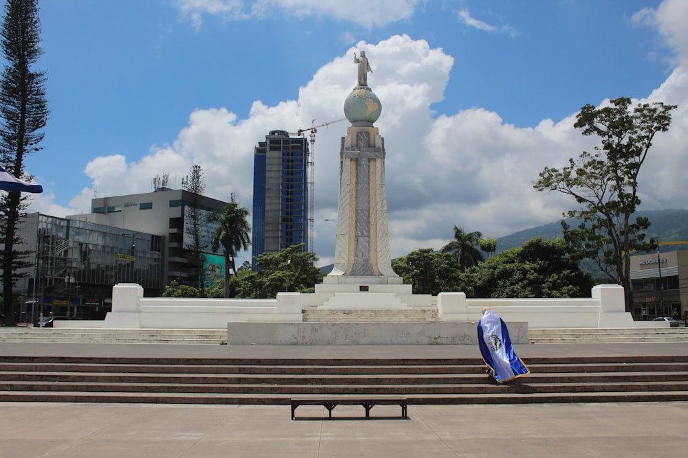 a monument with a clock tower in the background