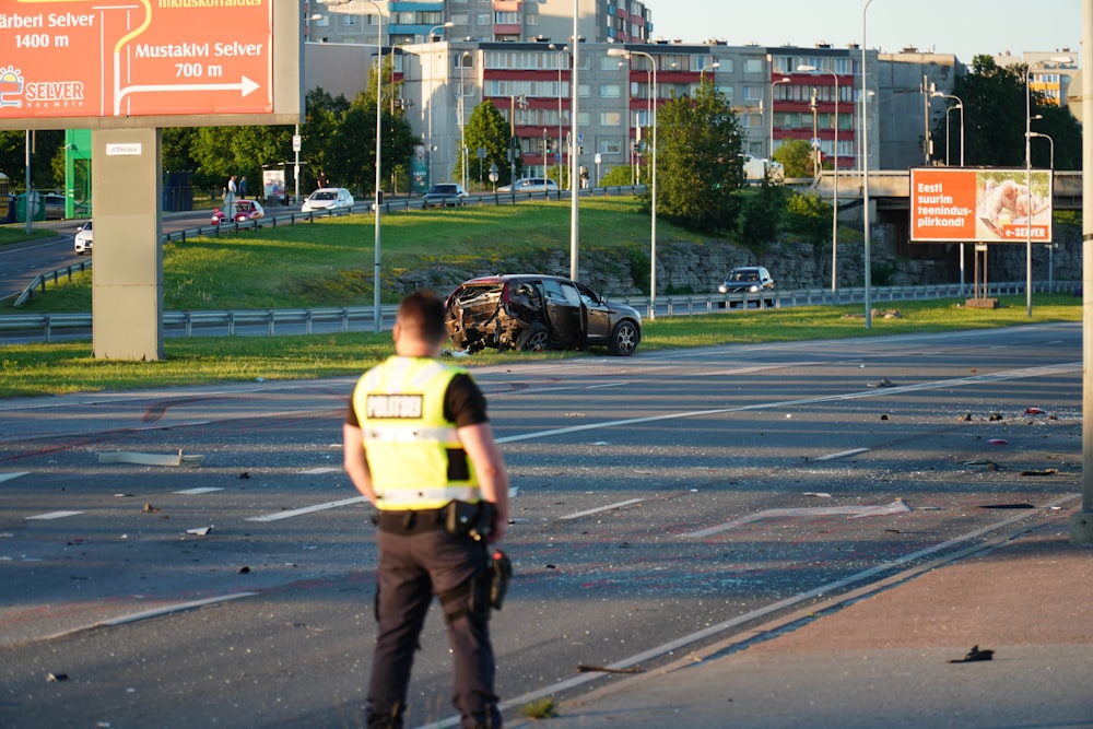 a police officer standing on the side of a road