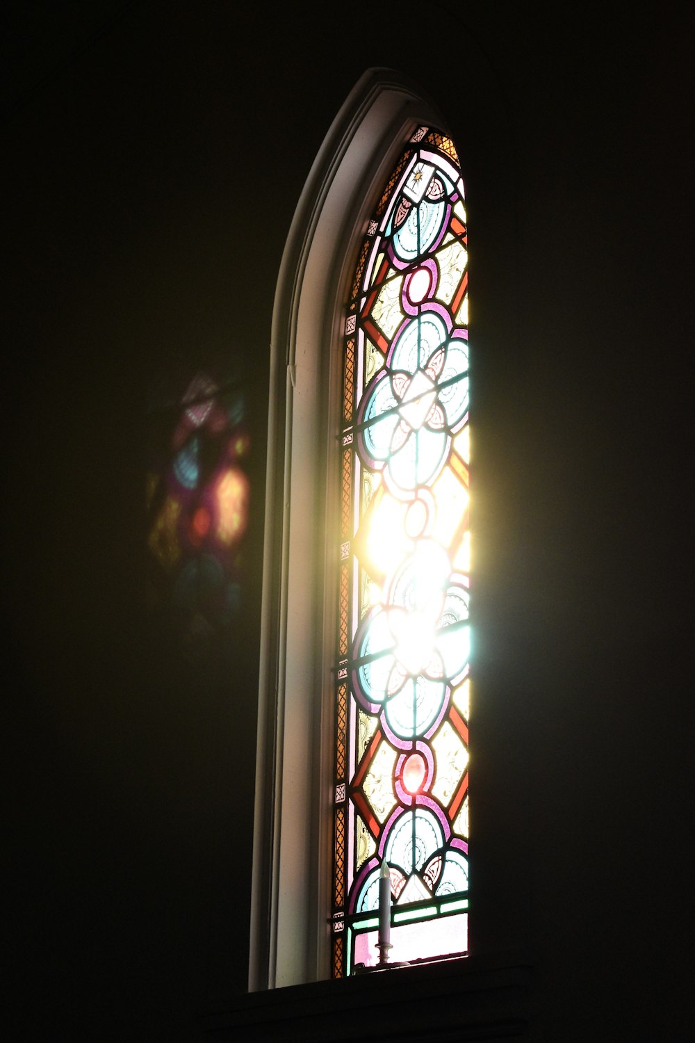 a stained glass window in a dark room