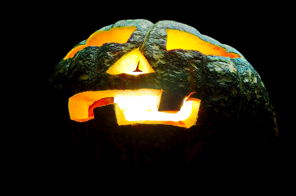 a carved pumpkin with glowing eyes and mouth