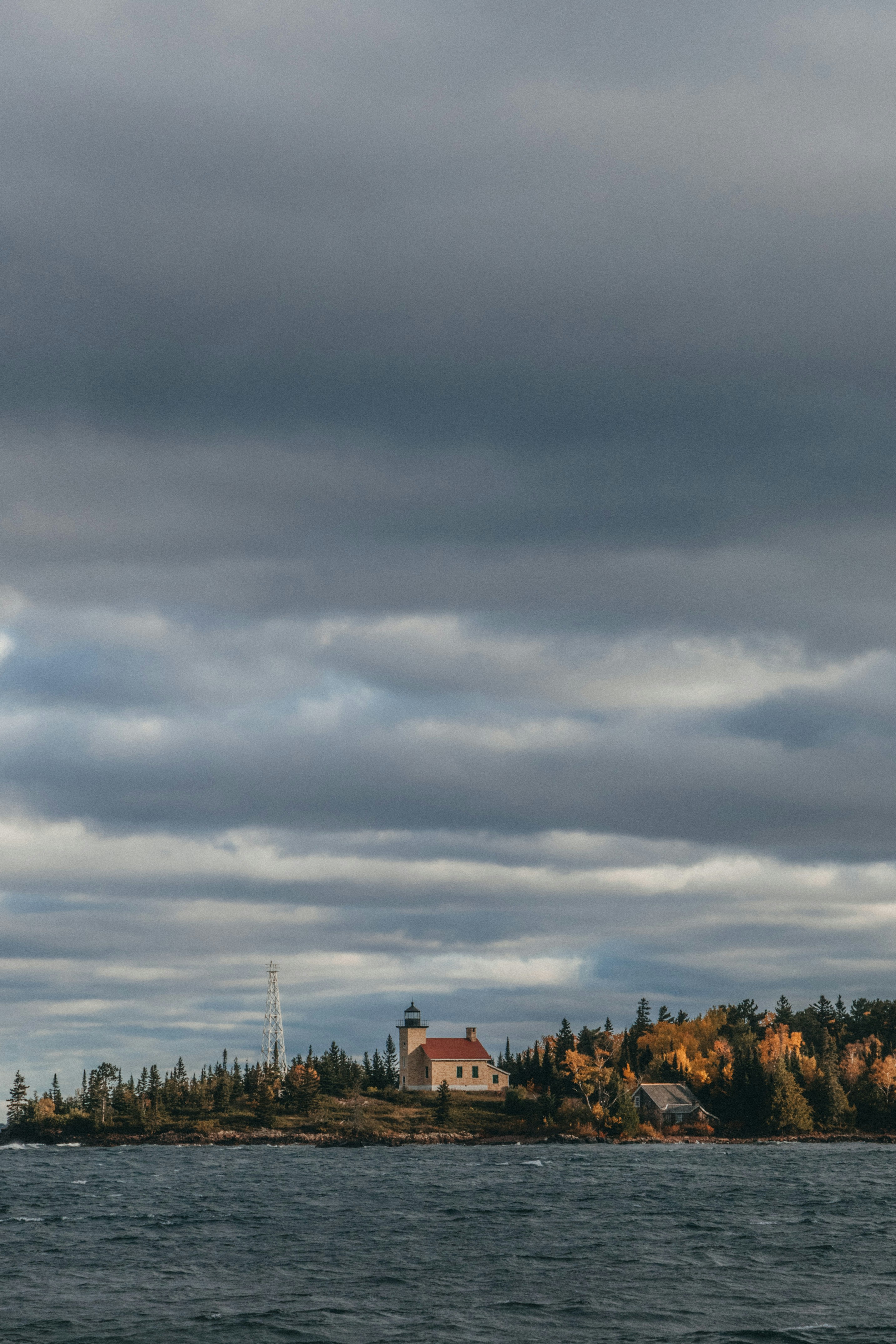 a lighthouse on a small island in the middle of the ocean