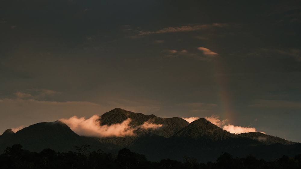 a mountain range with a rainbow in the distance