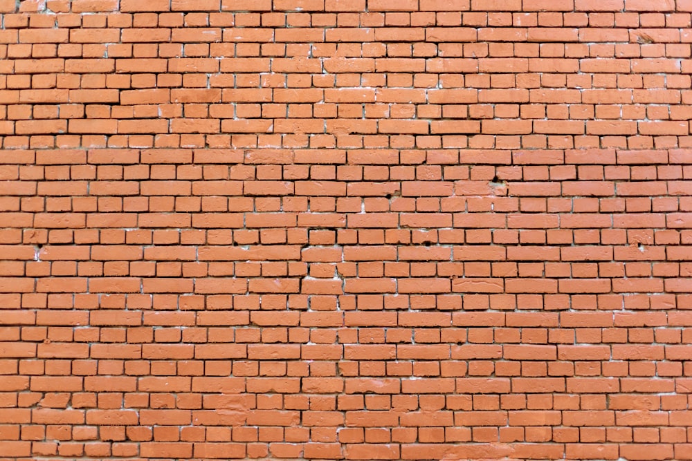 a close up of a brick wall with a clock on it