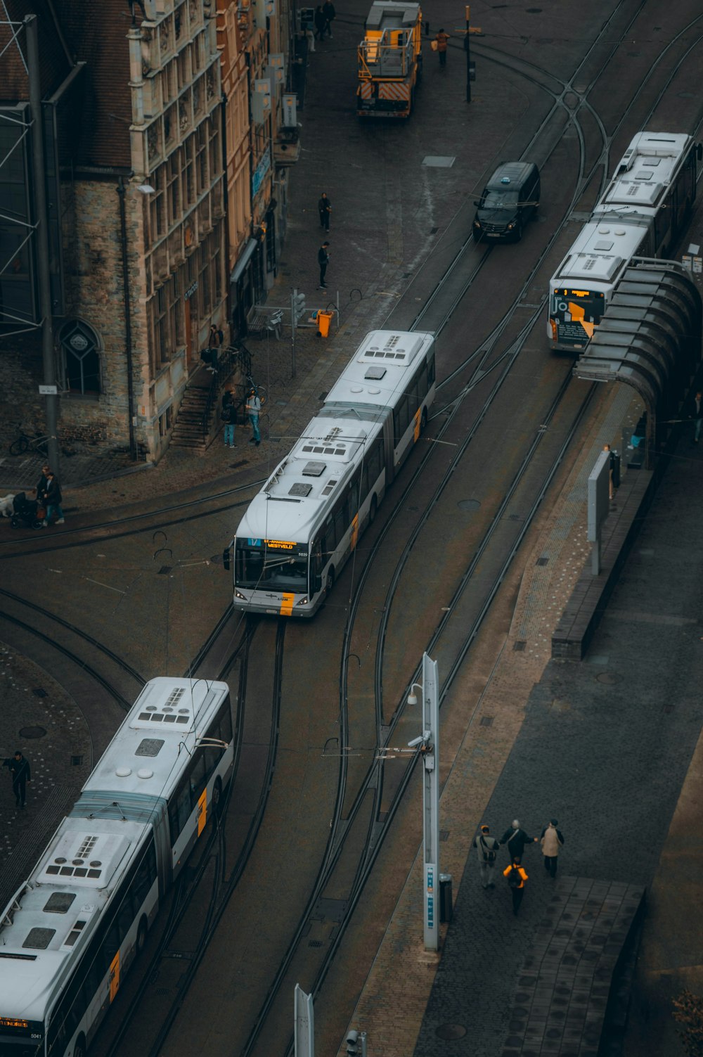 a group of buses parked next to each other on a street