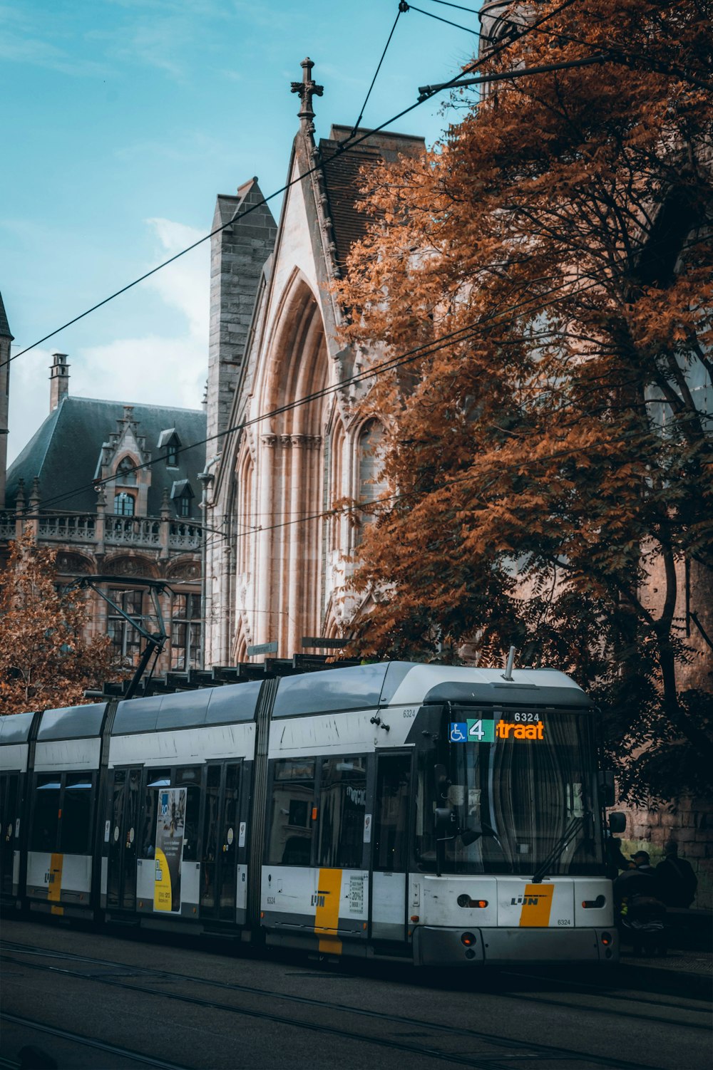 a train on a track in front of a church