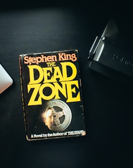 a book sitting on top of a desk next to a laptop