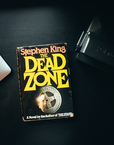 a book sitting on top of a desk next to a laptop