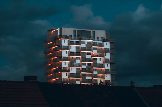 a tall building with windows lit up at night
