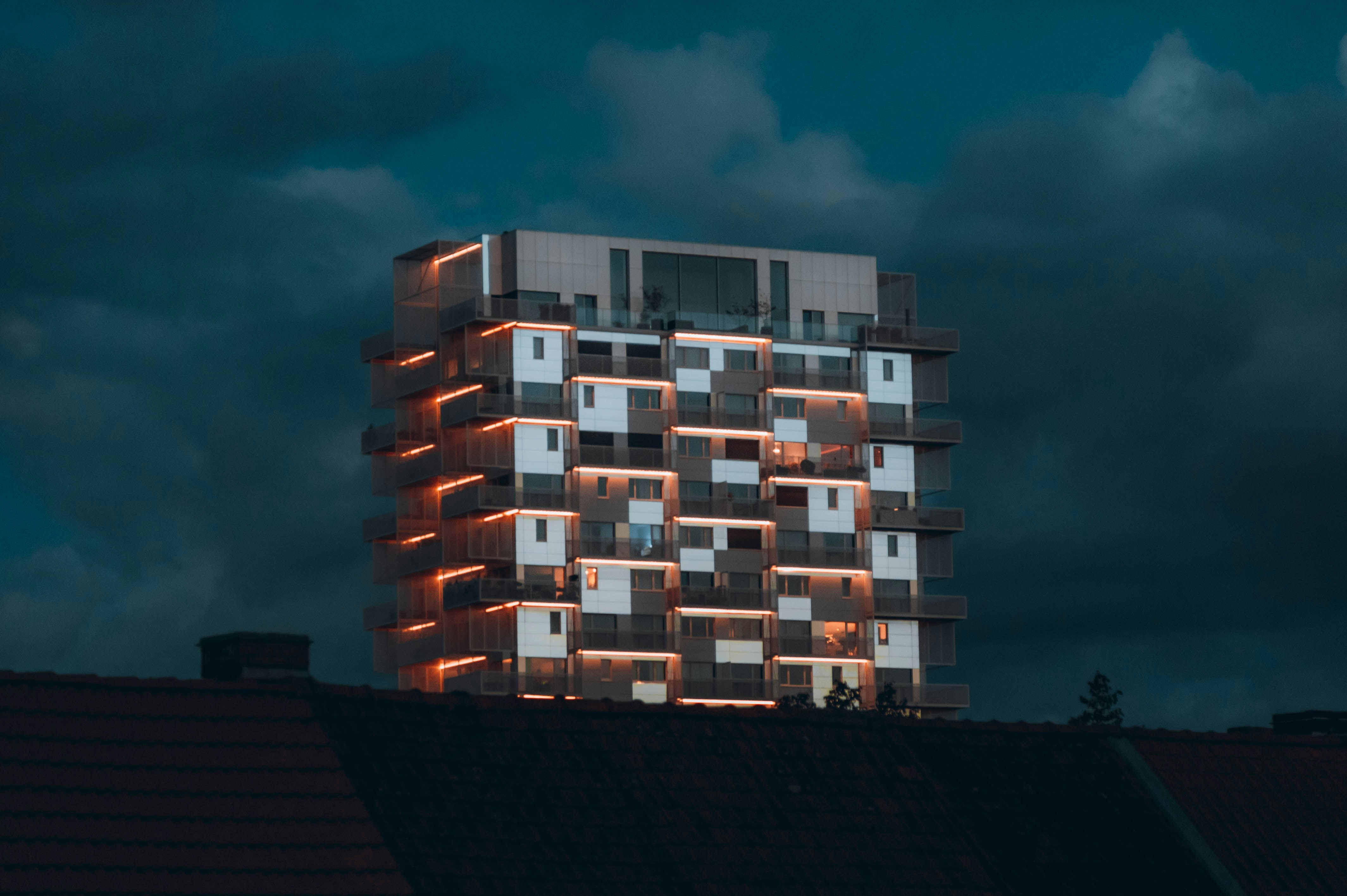a tall building with windows lit up at night