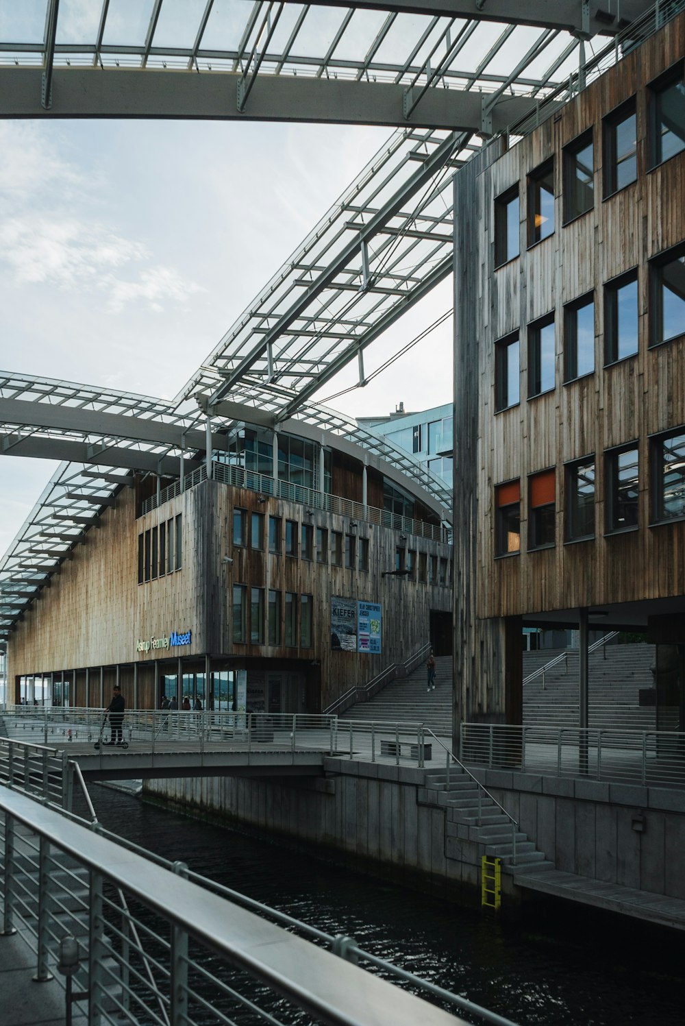 a building with a metal roof next to a body of water