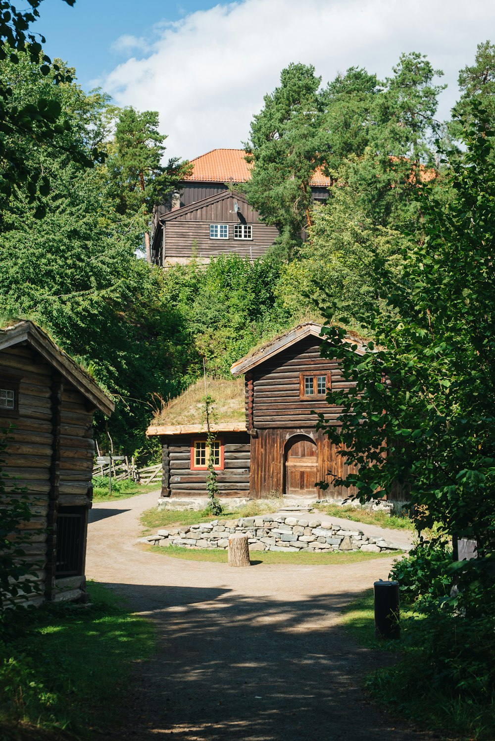 a couple of wooden buildings sitting in the middle of a forest