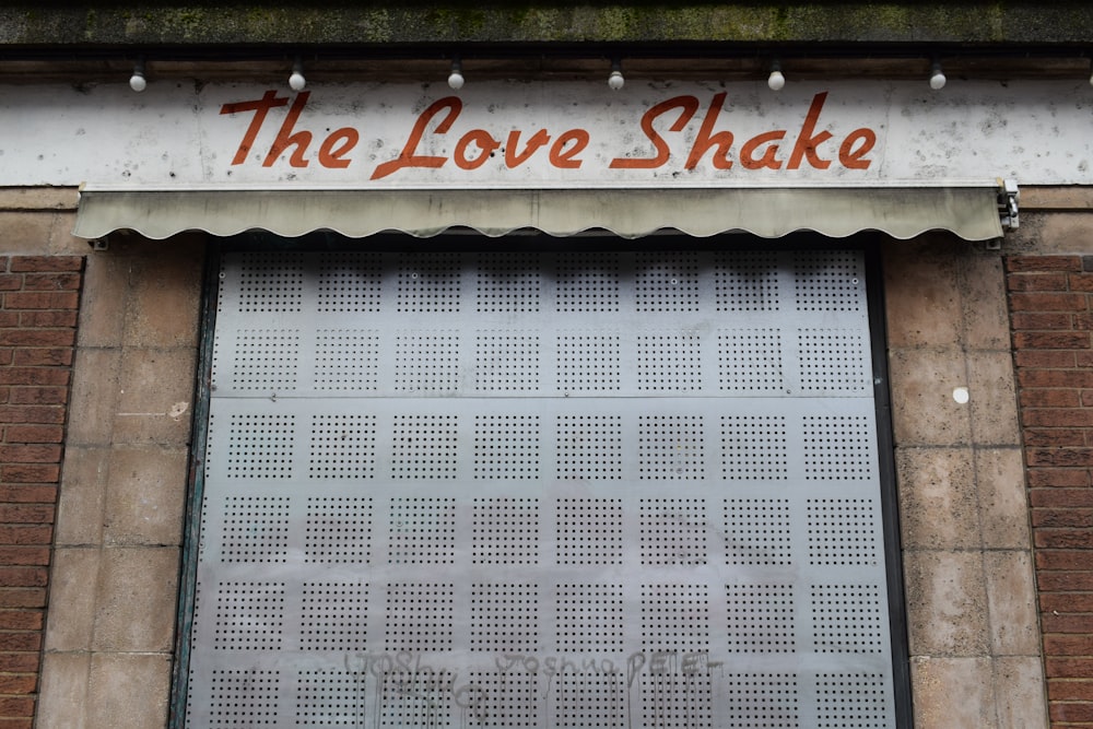 the love shake sign is above the door of the building