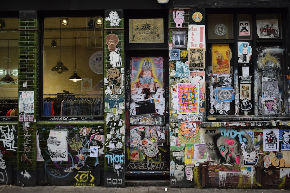 a store front covered in graffiti and stickers