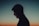 a man standing in front of a sunset