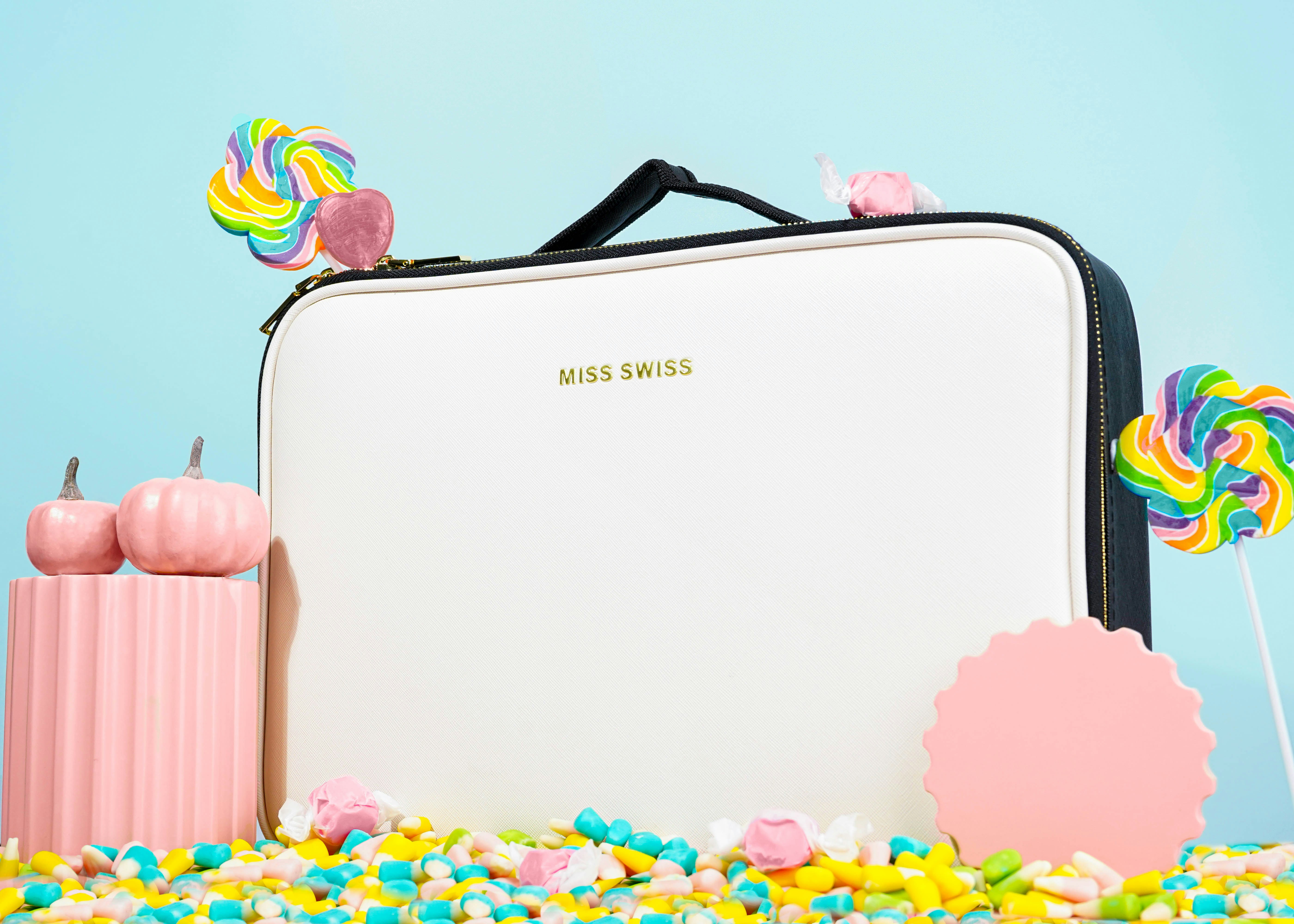 a suitcase sitting on a pile of candy