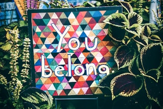 a quilt that says you belong surrounded by plants