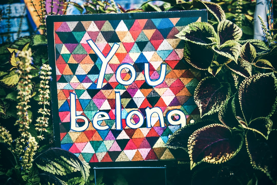 a sign that says you belong surrounded by plants, You belong | Instagram: @timmossholder