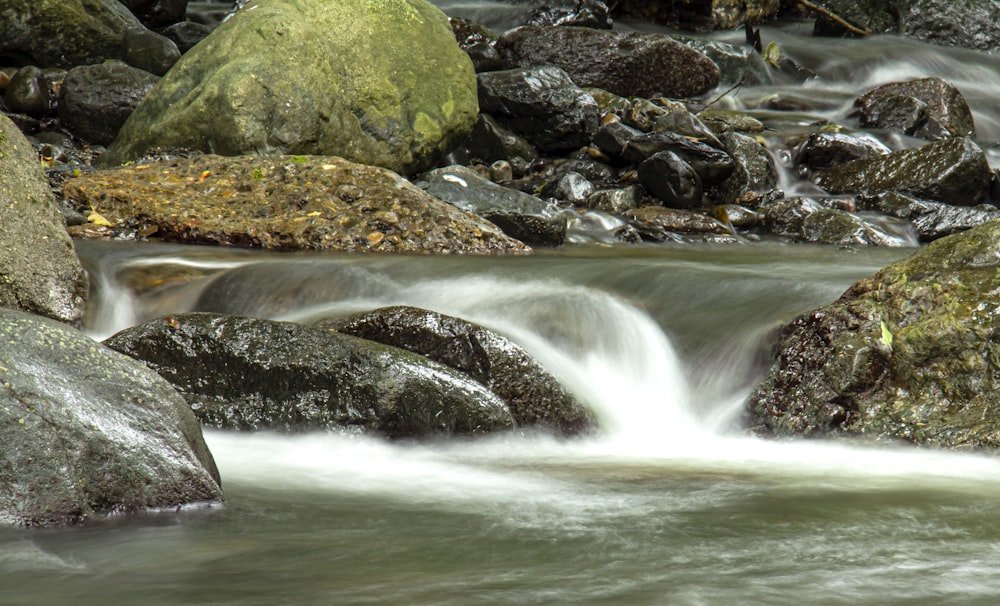 a stream of water running over rocks in a river