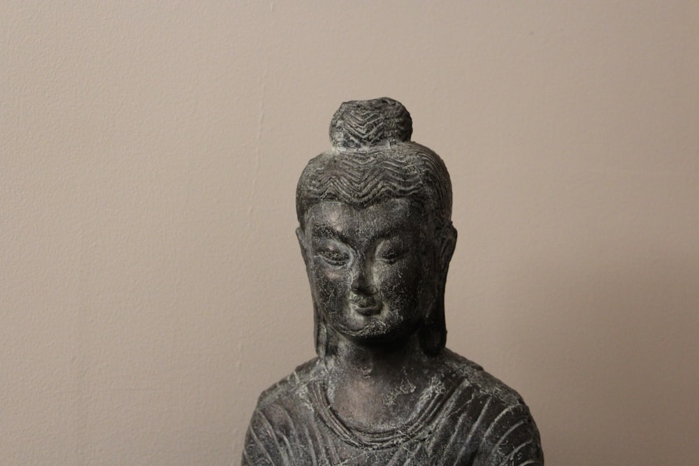 a statue of a woman with a bun on her head