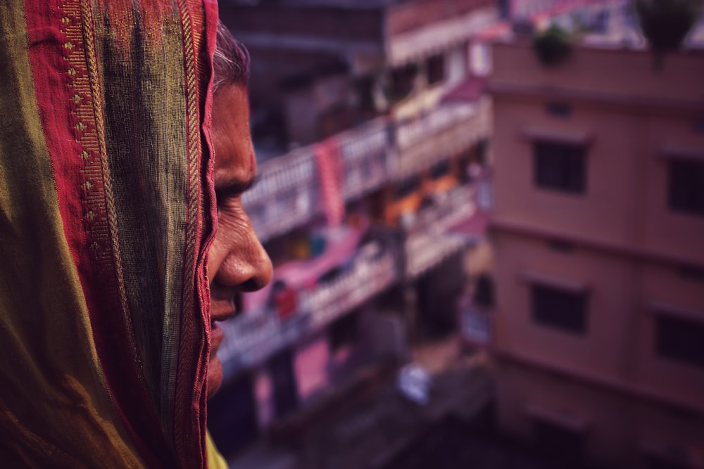 a woman in a colorful sari looks out over a city