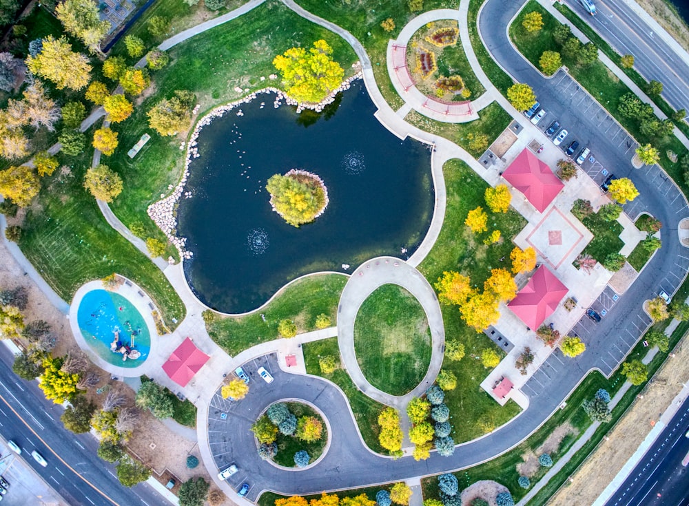 an aerial view of a park with a lake