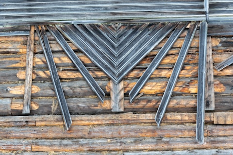 a close up of a wooden wall with metal bars