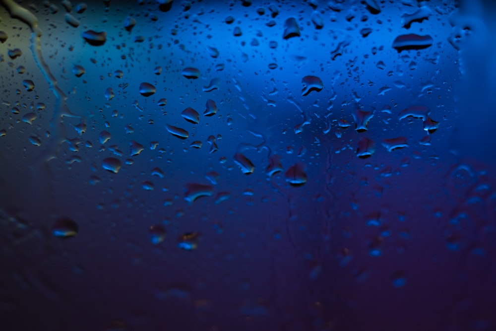 rain drops on a window with a blue background