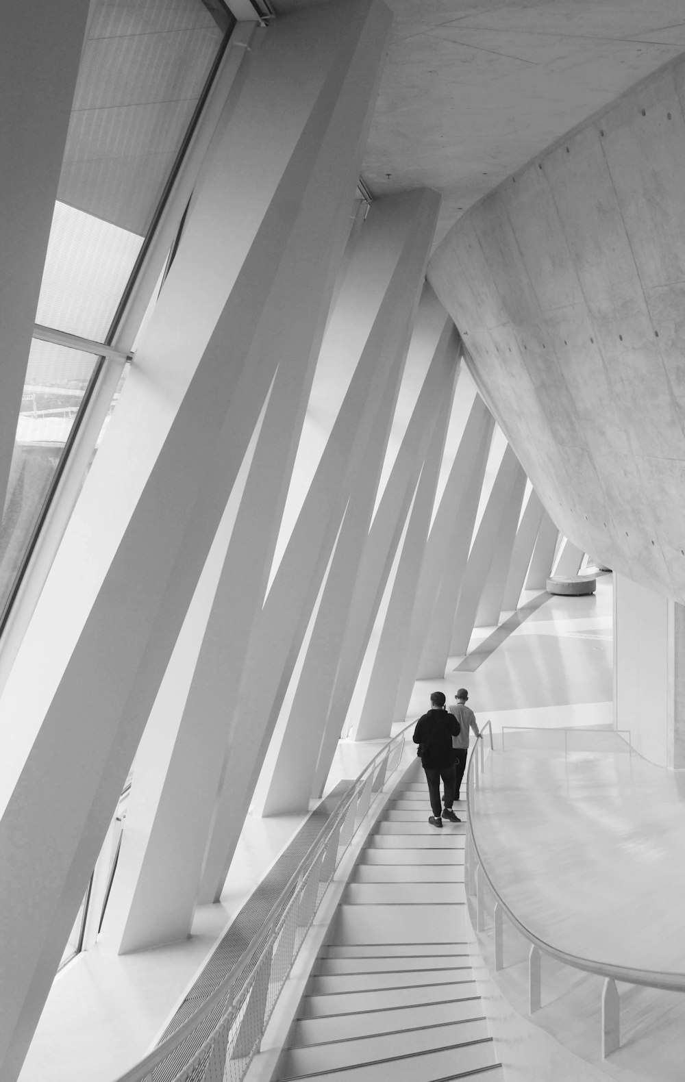 a man walking down a long white staircase