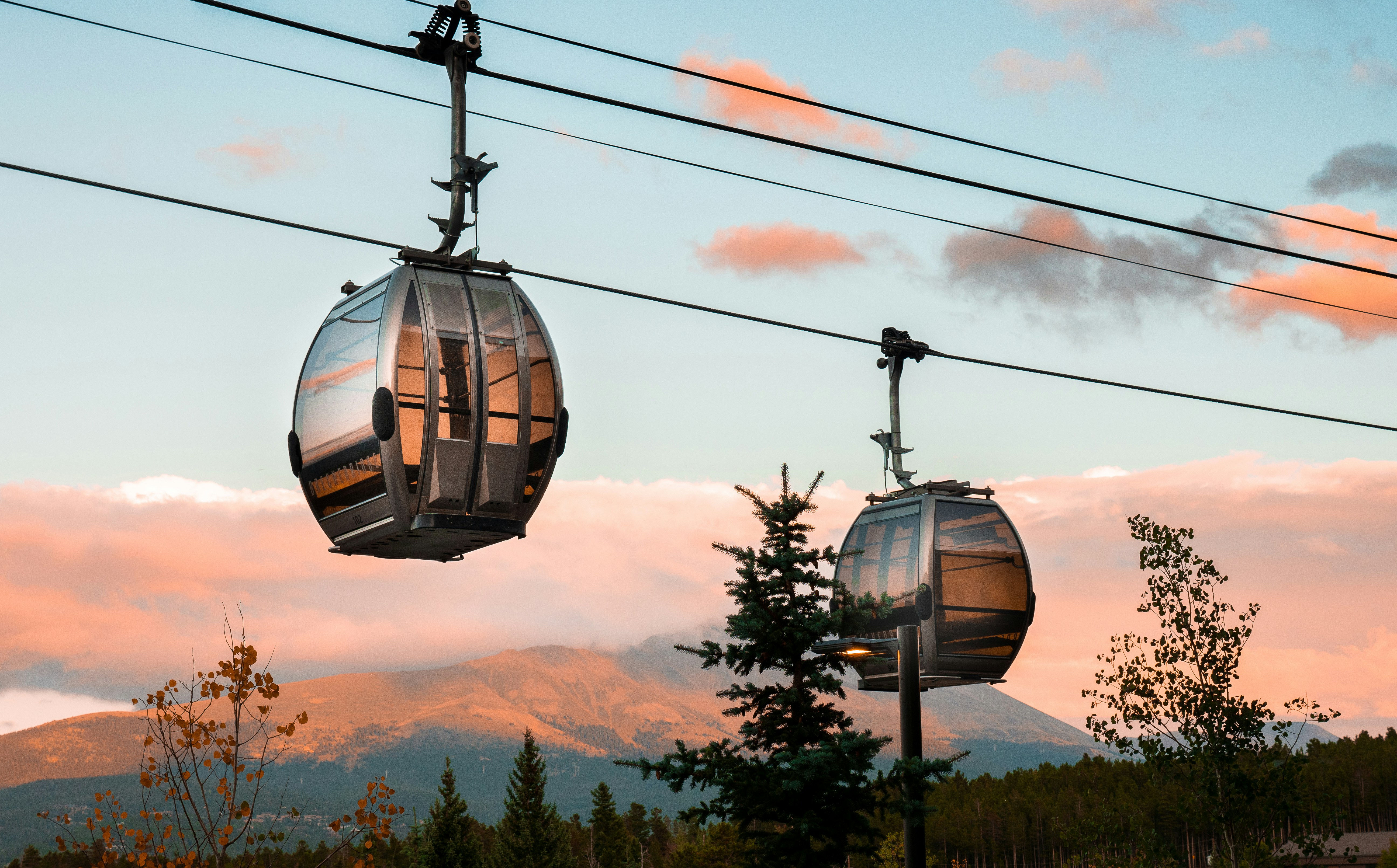 a couple of gondolas sitting on top of power lines