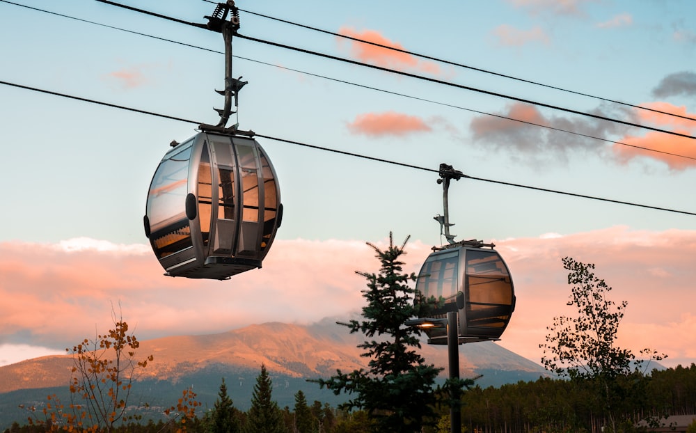 a couple of gondolas sitting on top of power lines