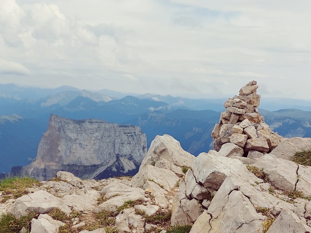 a rocky outcropping with mountains in the background