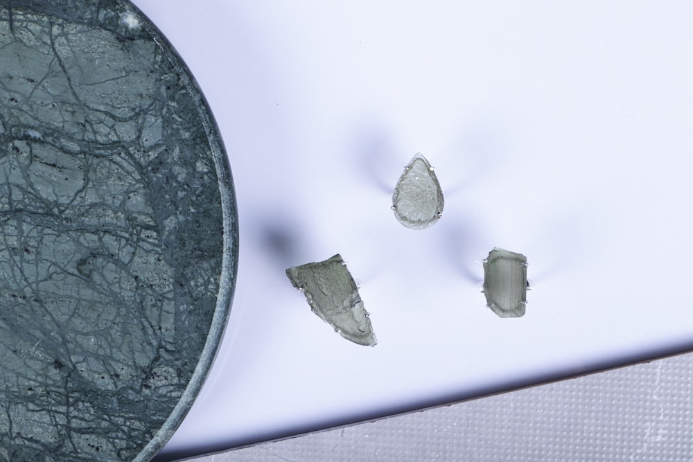 three pieces of glass sitting on top of a table