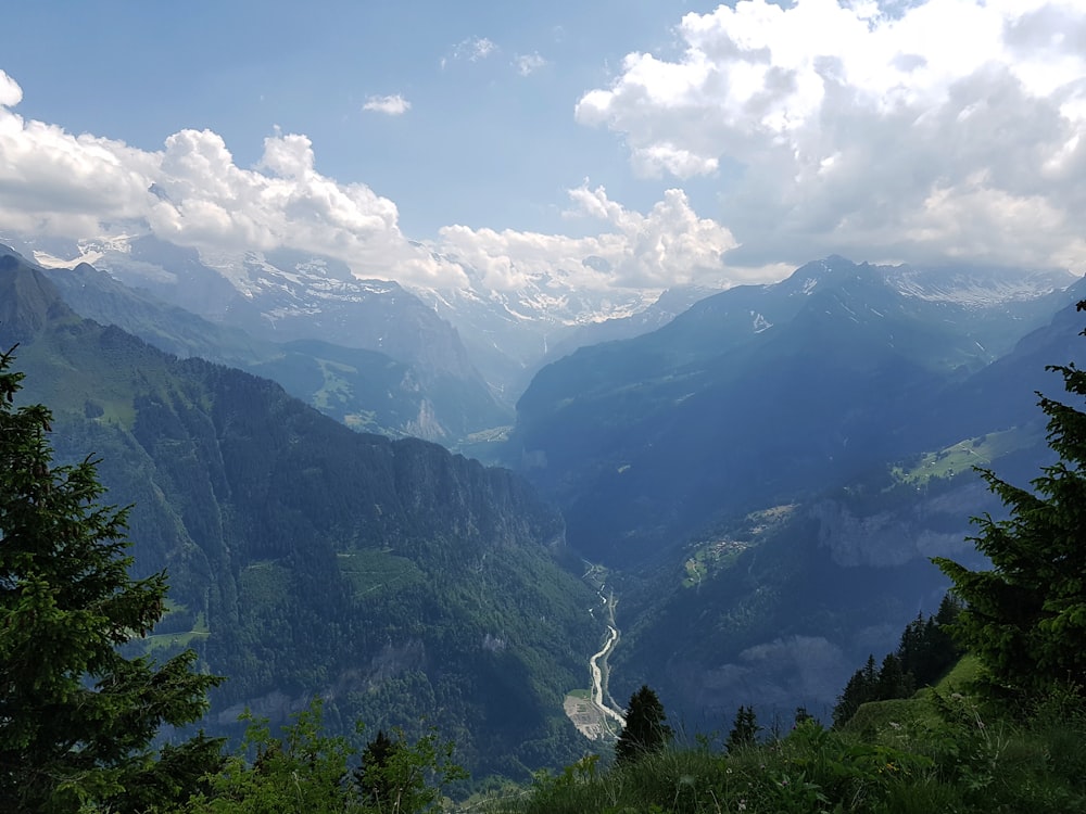 a view of a valley with mountains in the background